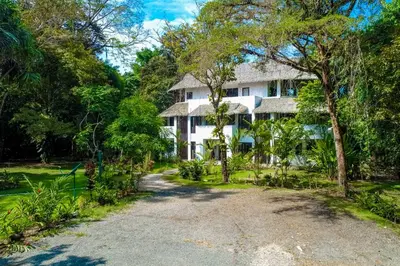 a house in the middle of a dirt road at Makara Mono Suite / 2nd Floor in Uvita