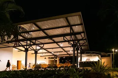 a building with awning over a patio at night at Hotel Nya in Montezuma