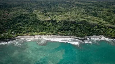 an aerial view of an island in the ocean at Hotel Nya in Montezuma