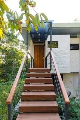 a stairway leading up to a house with a door at Hotel Nya in Montezuma