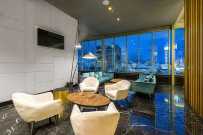 a living room with a table and chairs and a couch at Gran Hotel Costa Rica, Curio Collection By Hilton in San José