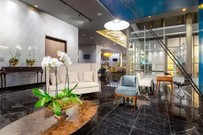 a lobby with a white couch and a table and chairs at Gran Hotel Costa Rica, Curio Collection By Hilton in San José