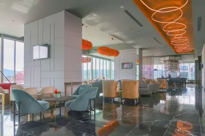 a lobby with chairs and tables in a building at Gran Hotel Costa Rica, Curio Collection By Hilton in San José