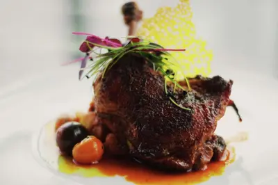 a piece of meat with vegetables on a plate at Gran Hotel Costa Rica, Curio Collection By Hilton in San José