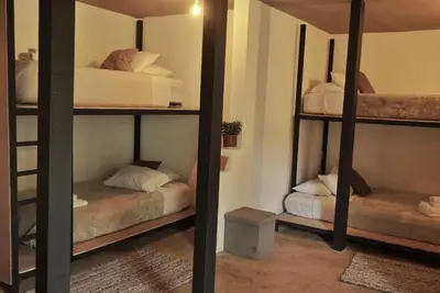 a room with two bunk beds in a room at OutBox Inn in Monteverde Costa Rica
