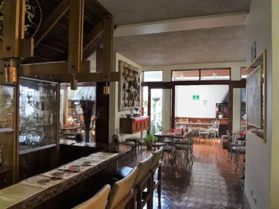 a restaurant with a bar with chairs and tables at Casa Mora B&B in Cartago