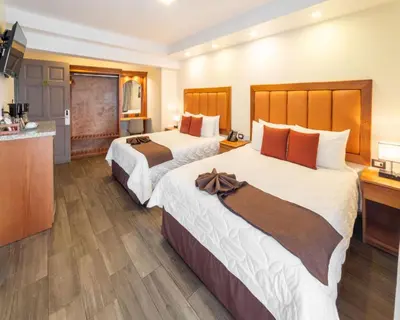 a hotel room with two beds and a kitchen at Hotel & Spa Poco a Poco - Costa Rica in Monteverde Costa Rica