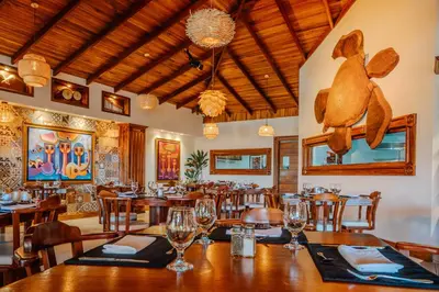 a restaurant with tables and chairs and a teddy bear on the wall at Hotel & Spa Poco a Poco - Costa Rica in Monteverde Costa Rica