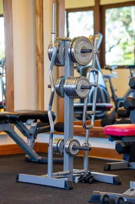 a gym with a rack of weights at Hotel & Spa Poco a Poco - Costa Rica in Monteverde Costa Rica