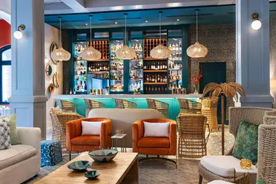 a lobby with chairs and a bar at Santarena Hotel at Las Catalinas in Playa Flamingo