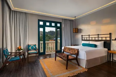 a bedroom with a bed and a table and a chair at Santarena Hotel at Las Catalinas in Playa Flamingo