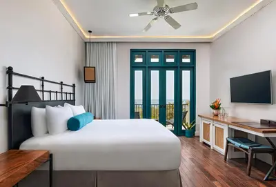 a bedroom with a bed and a desk with a television at Santarena Hotel at Las Catalinas in Playa Flamingo
