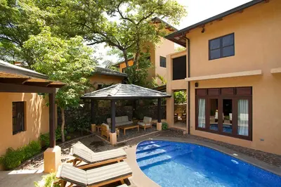 a house with a swimming pool and a gazebo at Jet Luxury at Langosta Beach Resort & Villas in Tamarindo