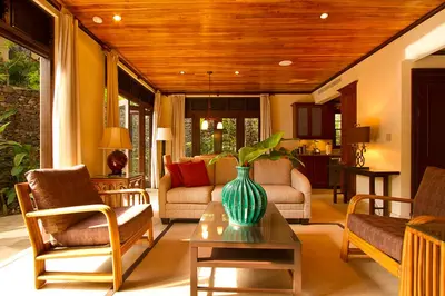 a living room with a vase on a coffee table at Jet Luxury at Langosta Beach Resort & Villas in Tamarindo