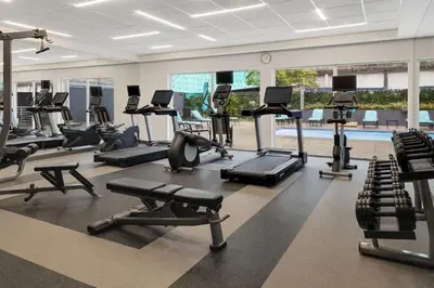 a gym with several treadmills and cardio machines at Courtyard by Marriott San Jose Airport Alajuela in Alajuela City