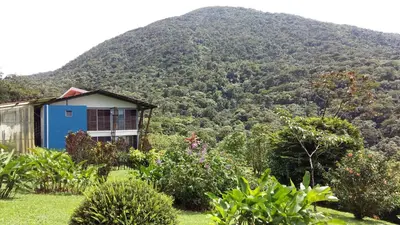 a house in front of a mountain at Celeste Mountain Lodge in Bijagua