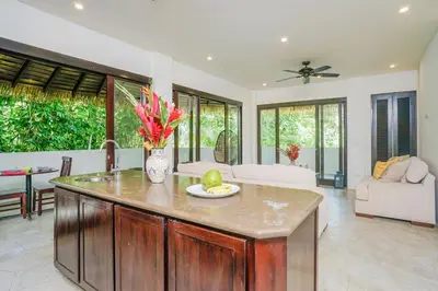 a kitchen with a center island in a living room at Makara Toucan Suite / 2nd Floor in Uvita