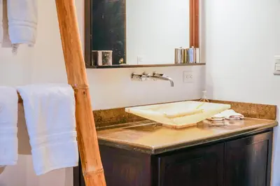 a bathroom with a sink and a mirror at Makara Toucan Suite / 2nd Floor in Uvita