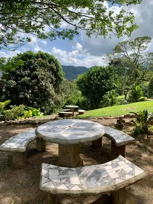 a stone picnic table in a park with a view at Epic Adventure Lodge in San Miguel