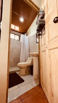 a small bathroom with a toilet and a sink at Casa Encantada offers you Two-Bedroom House, 1 Tiny Apartment & 3 Double Rooms in Manuel Antonio