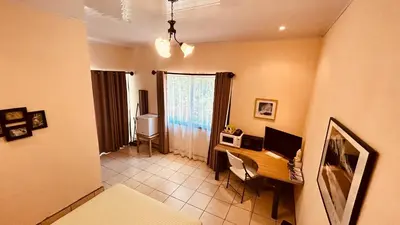 a room with a desk with a computer on it at Casa Encantada offers you Two-Bedroom House, 1 Tiny Apartment & 3 Double Rooms in Manuel Antonio