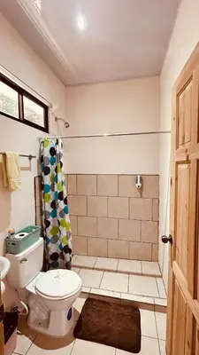 a bathroom with a toilet and a shower at Casa Encantada offers you Two-Bedroom House, 1 Tiny Apartment & 3 Double Rooms in Manuel Antonio