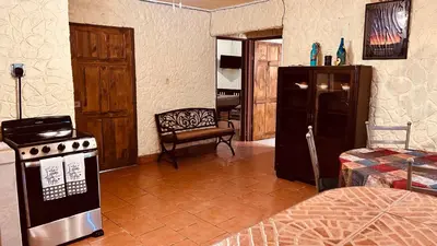 a kitchen with a stove and a refrigerator at Casa Encantada offers you Two-Bedroom House, 1 Tiny Apartment & 3 Double Rooms in Manuel Antonio