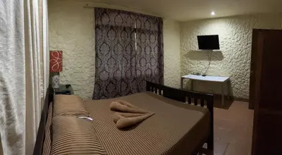 a bedroom with a bed with a towel on it at Casa Encantada offers you Two-Bedroom House, 1 Tiny Apartment & 3 Double Rooms in Manuel Antonio