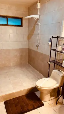 a bathroom with a toilet and a shower at Casa Encantada offers you Two-Bedroom House, 1 Tiny Apartment & 3 Double Rooms in Manuel Antonio