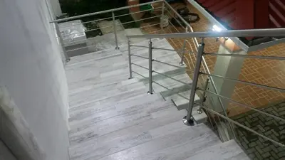 a staircase with a metal railing next to a room at LOFTSCACAO APARTMENTS, Villas Cacao, near to Playa Bonita Limón in Puerto Limón