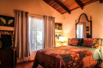 a bedroom with a bed and a window at Magic Mountain Views Villa in Atenas