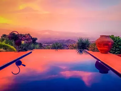 a pool with a vase sitting on top of it at Magic Mountain Views Villa in Atenas