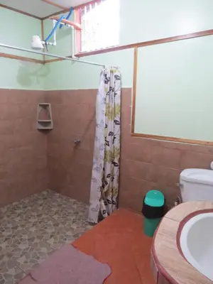 a bathroom with a shower and a sink at Poponjoche Lodge Caño Negro in Caño Negro