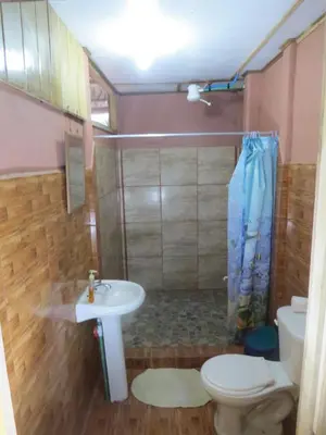 a bathroom with a sink and a toilet and a shower at Poponjoche Lodge Caño Negro in Caño Negro