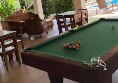 a pool table with balls on top of it at Tropical Garden Hotel in Jacó