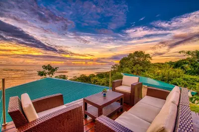 a view of the ocean from the deck of a villa at El Castillo Luxury Boutique Hotel- in Ojochal