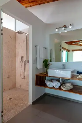 a bathroom with a sink and a shower and a mirror at El Castillo Luxury Boutique Hotel- in Ojochal