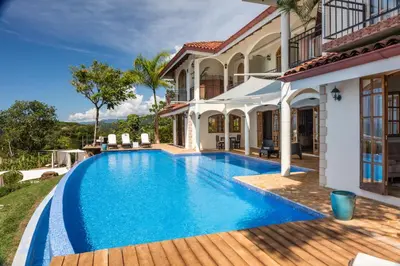 a swimming pool in the backyard of a house at El Castillo Luxury Boutique Hotel- in Ojochal