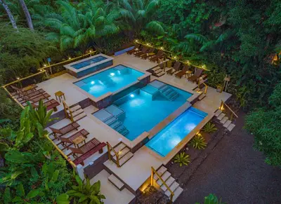 an overhead view of a swimming pool with lounge chairs at Copa De Arbol Beach & Rainforest Resort in Drake