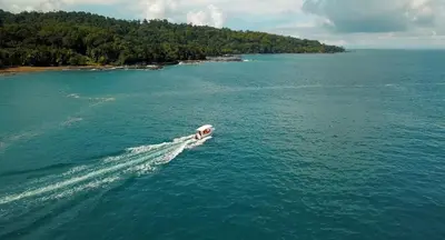 a boat in the water in the ocean at Copa De Arbol Beach & Rainforest Resort in Drake