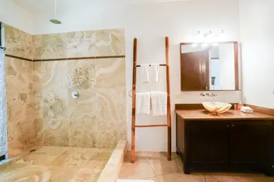 a bathroom with a shower and a sink at Makara Suite Mariposa Ground Floor in Uvita