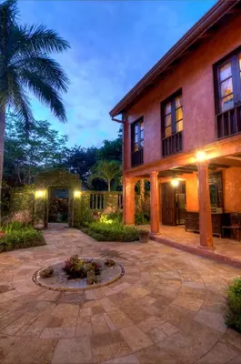 a courtyard with a fire pit in front of a house at Hacienda Barrigona in Sámara