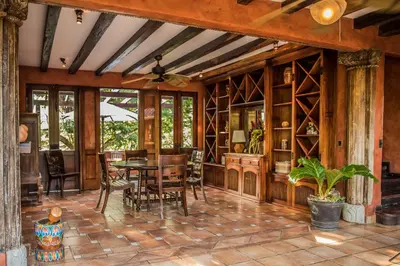 an open living room with a table and chairs at Hacienda Barrigona in Sámara