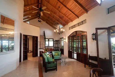 an open living room with a wooden ceiling at Hacienda Barrigona in Sámara