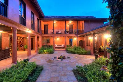 a courtyard with a fire pit in the middle of a building at Hacienda Barrigona in Sámara