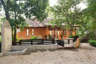 a house with a fence in front of it at Hacienda Barrigona in Sámara