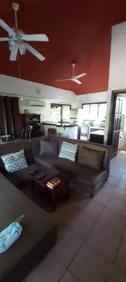 a living room with a couch and a ceiling fan at Massai Apartments in Playa Flamingo