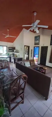 a living room with a couch and a ceiling fan at Massai Apartments in Playa Flamingo