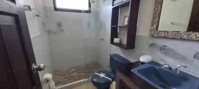 a bathroom with a blue toilet and a sink at Massai Apartments in Playa Flamingo