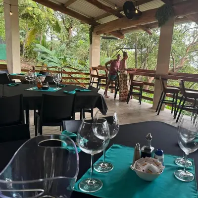 a table in a restaurant with wine glasses on it at Cocobolo Beach Boutique Hotel in San Juanillo